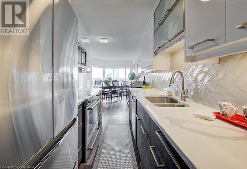 Tiled backsplash - 1414 King Street E Unit# 1106, Kitchener, ON - Indoor Photo Showing Kitchen With Double Sink