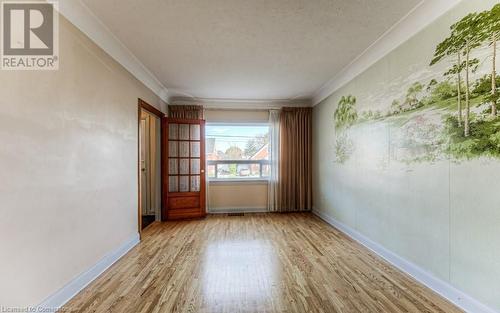 Unfurnished room with light hardwood / wood-style flooring and crown molding - 55 Ellis Avenue, Kitchener, ON - Indoor Photo Showing Other Room