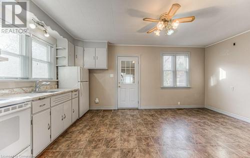 Kitchen with white appliances, white cabinets, crown molding, sink, and ceiling fan - 55 Ellis Avenue, Kitchener, ON - Indoor Photo Showing Kitchen