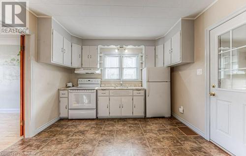 Kitchen featuring white cabinetry, sink, crown molding, and white appliances - 55 Ellis Avenue, Kitchener, ON - Indoor Photo Showing Kitchen