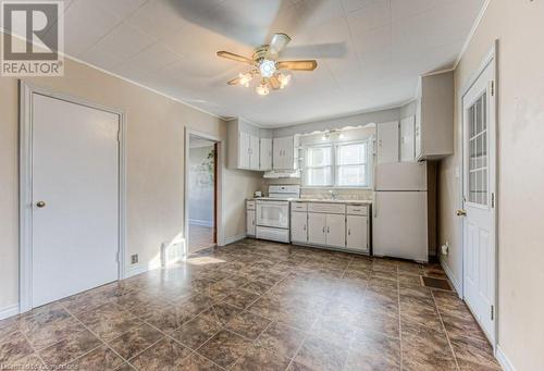 Kitchen featuring white appliances, white cabinets, crown molding, sink, and ceiling fan - 55 Ellis Avenue, Kitchener, ON - Indoor Photo Showing Kitchen