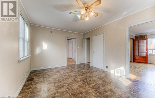 Empty room featuring dark wood-type flooring, ceiling fan, and ornamental molding - 55 Ellis Avenue, Kitchener, ON - Indoor Photo Showing Other Room