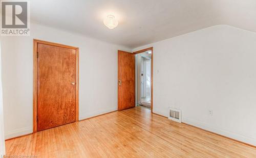 Spare room featuring light wood-type flooring and lofted ceiling - 55 Ellis Avenue, Kitchener, ON - Indoor Photo Showing Other Room