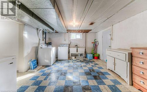 Basement with white refrigerator and washer and clothes dryer - 55 Ellis Avenue, Kitchener, ON - Indoor Photo Showing Laundry Room