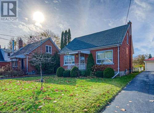 View of front facade with a front yard and a porch - 55 Ellis Avenue, Kitchener, ON - Outdoor With Facade