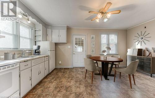 Kitchen featuring white cabinets, ceiling fan, crown molding, and sink - 55 Ellis Avenue, Kitchener, ON - Indoor Photo Showing Other Room