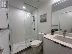 Bathroom featuring vanity, toilet, and walk in shower - 