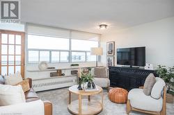 Living room facing balcony and black console - 