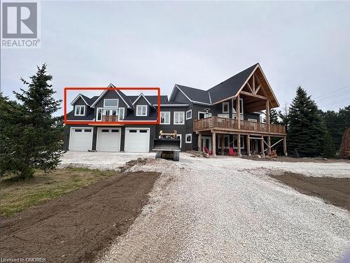 View of front of house with a garage and a deck - 796363 Grey 19 Road, The Blue Mountains, ON - Outdoor