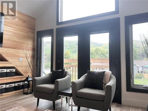 Sitting room featuring high vaulted ceiling, light hardwood / wood-style flooring, and wood walls - 796363 Grey 19 Road, The Blue Mountains, ON - Indoor Photo Showing Other Room