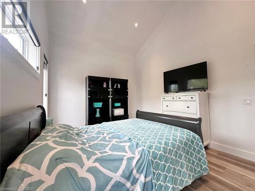 Bedroom with light hardwood / wood-style flooring and high vaulted ceiling - 796363 Grey 19 Road, The Blue Mountains, ON - Indoor Photo Showing Bedroom