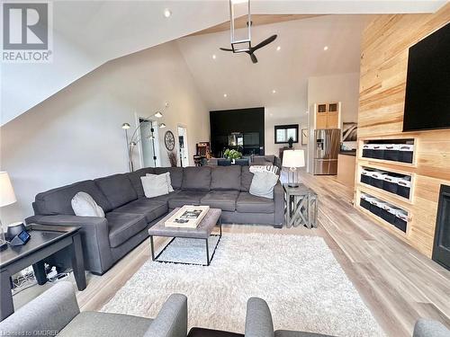 Living room with wooden walls, high vaulted ceiling, and light hardwood / wood-style floors - 796363 Grey 19 Road, The Blue Mountains, ON - Indoor Photo Showing Living Room