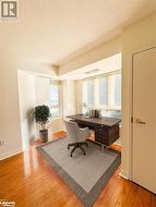 Home office with light hardwood  floors overlooking the waterfront. - 