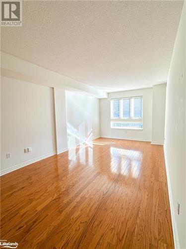 Primary bedroom hardwood flooring - 16 Raglan Street E Unit# 211, Collingwood, ON - Indoor Photo Showing Other Room