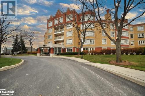 View of outdoor building at dusk - 16 Raglan Street E Unit# 211, Collingwood, ON - Outdoor With Facade