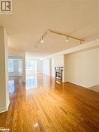 Empty room with light hardwood flooring,  and track lighting - 