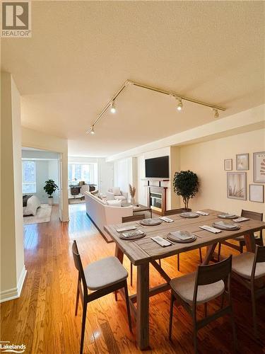 Dining space with rail lighting, and light wood flooring - 16 Raglan Street E Unit# 211, Collingwood, ON - Indoor Photo Showing Dining Room