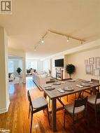 Dining space with rail lighting, and light wood flooring - 