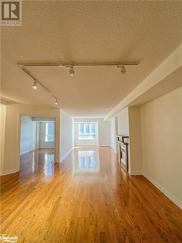 Spare room featuring light hardwood, rail lighting - 16 Raglan Street E Unit# 211, Collingwood, ON - Indoor Photo Showing Other Room