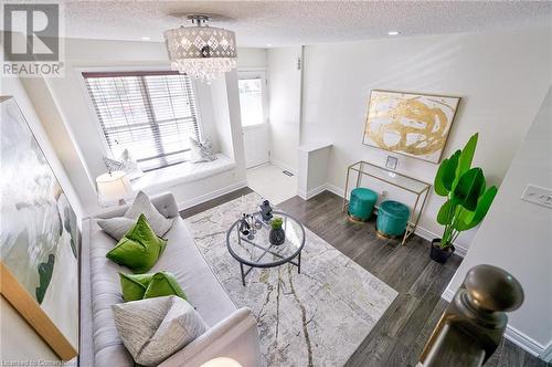 Living room featuring dark wood-type flooring and a chandelier - 1145 Riddell Crescent, Hamilton, ON - Indoor