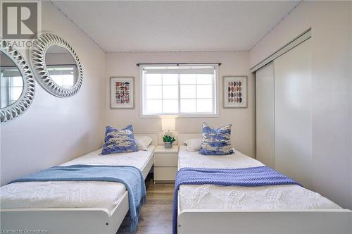 Bedroom featuring dark hardwood / wood-style floors and a closet - 1145 Riddell Crescent, Hamilton, ON - Indoor Photo Showing Bedroom