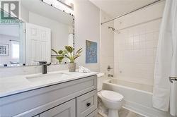 Full bathroom with shower / bath combo, toilet, and vanity - 