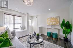 Living room with wood-type flooring and an inviting chandelier - 