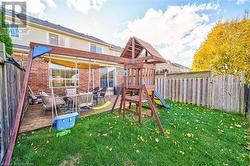 View of play area featuring a lawn and a wooden deck - 