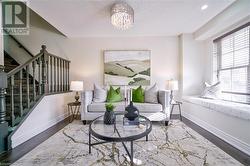 Living area featuring a chandelier and hardwood / wood-style flooring - 