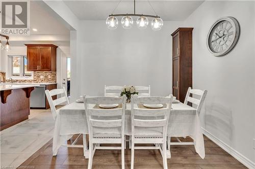 Dining space with light hardwood / wood-style floors - 48 Isaiah Drive, Kitchener, ON 