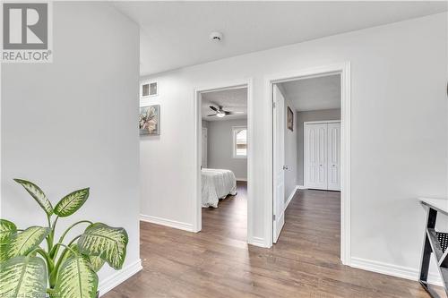 Hall with a textured ceiling and dark wood-type flooring - 48 Isaiah Drive, Kitchener, ON 