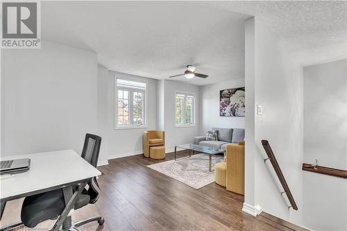 Home office featuring dark hardwood / wood-style floors, ceiling fan, and a textured ceiling - 48 Isaiah Drive, Kitchener, ON 