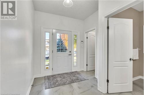 Foyer entrance featuring a textured ceiling - 48 Isaiah Drive, Kitchener, ON 