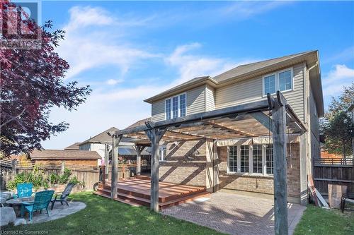 Back of house with a pergola, a wooden deck, a patio area, and a yard - 48 Isaiah Drive, Kitchener, ON 