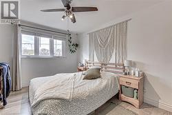 Bedroom featuring ceiling fan and light hardwood / wood-style flooring - 