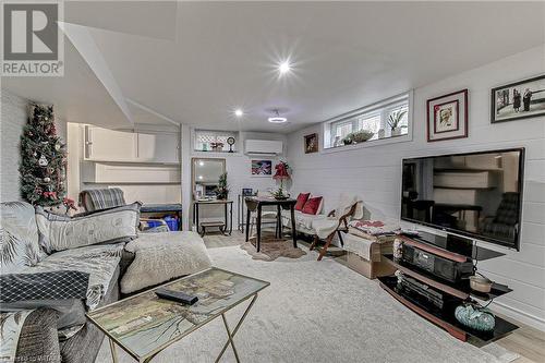 Living room featuring a wall mounted air conditioner and light wood-type flooring - 476 Prospect Street, Kitchener, ON 