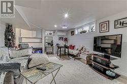 Living room featuring a wall mounted air conditioner and light wood-type flooring - 