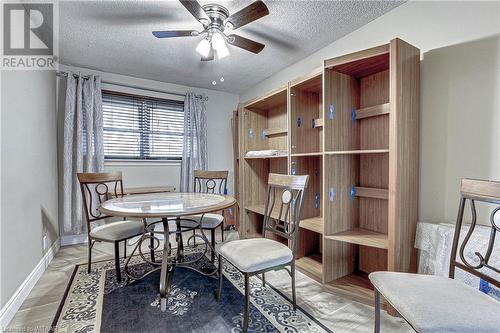 Dining area featuring wood-type flooring, a textured ceiling, and ceiling fan - 476 Prospect Street, Kitchener, ON 