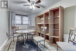 Dining area featuring wood-type flooring, a textured ceiling, and ceiling fan - 