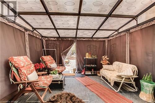 Sitting room featuring wooden walls, carpet, and vaulted ceiling - 476 Prospect Street, Kitchener, ON 