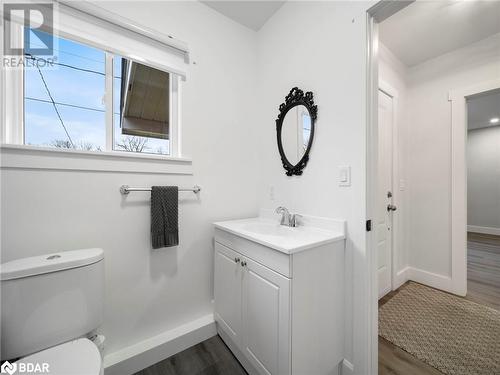 Bathroom featuring wood-type flooring, vanity, and toilet - 206 Mary Street, Orillia, ON 