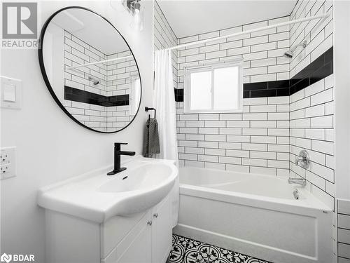 Bathroom with vanity and shower / bath combo with shower curtain - 206 Mary Street, Orillia, ON 