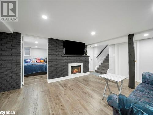 Living room featuring a fireplace and light hardwood / wood-style flooring - 206 Mary Street, Orillia, ON 