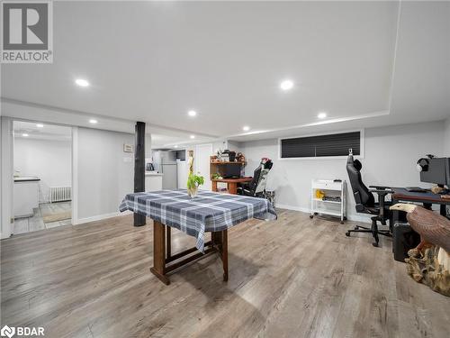 Recreation room with radiator heating unit and light hardwood / wood-style flooring - 206 Mary Street, Orillia, ON 