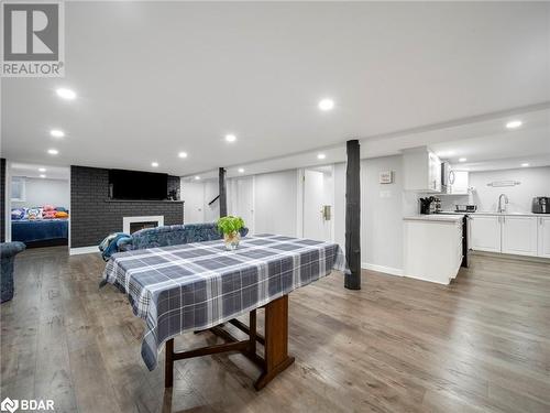 Dining area with a fireplace, light hardwood / wood-style flooring, and sink - 206 Mary Street, Orillia, ON 