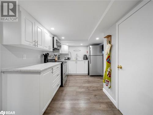 Kitchen featuring white cabinets, sink, stainless steel appliances, and light hardwood / wood-style flooring - 206 Mary Street, Orillia, ON 