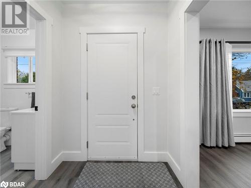 Foyer entrance with baseboard heating and hardwood / wood-style flooring - 206 Mary Street, Orillia, ON 