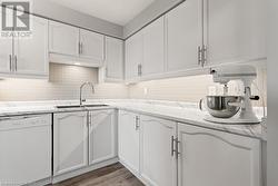 Kitchen featuring dishwasher, white cabinets, and sink - 