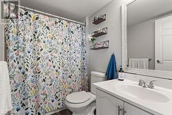 Bathroom with vanity, toilet, and wood-type flooring - 