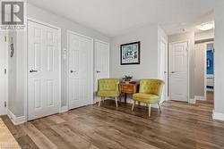 Sitting room with wood-type flooring and a textured ceiling - 